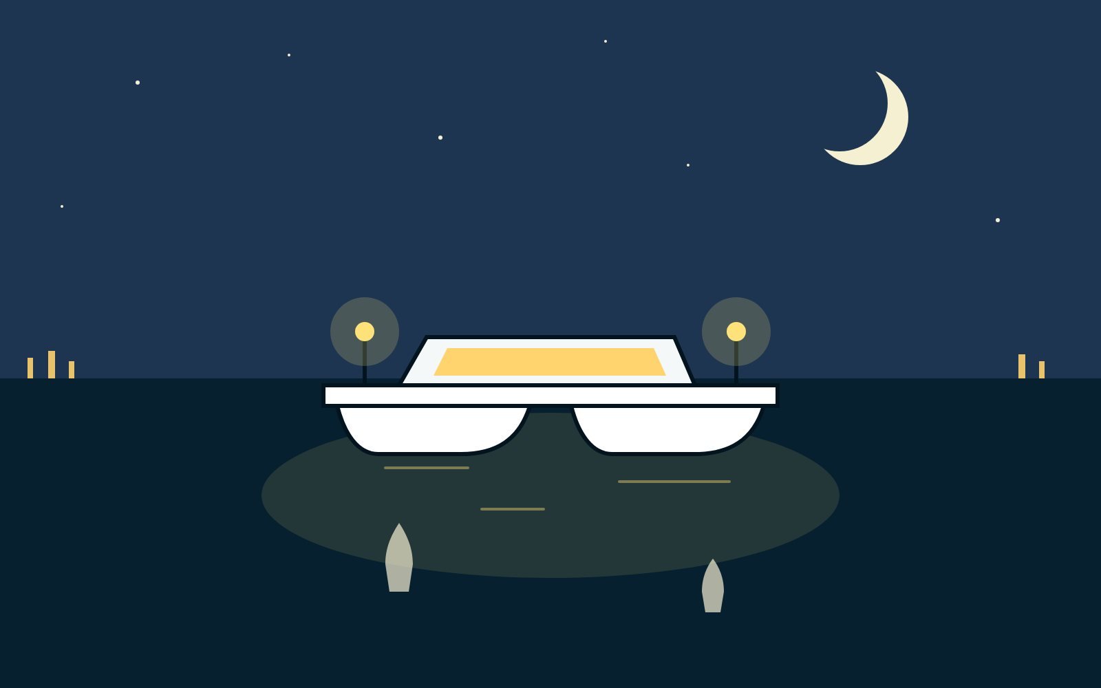 A catamaran with deck lights glowing on the water under a crescent moon